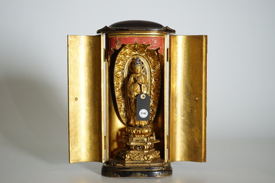 A Japanese lacquered and gilt wood &quot;Zushi&quot; shrine with a standing Buddha on a lotus throne, Edo, 17/18th C.